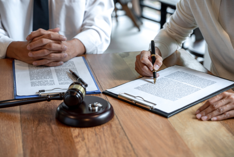 Image is of a married couple signing legal separation agreements, concept of the legal separation process in Tennessee