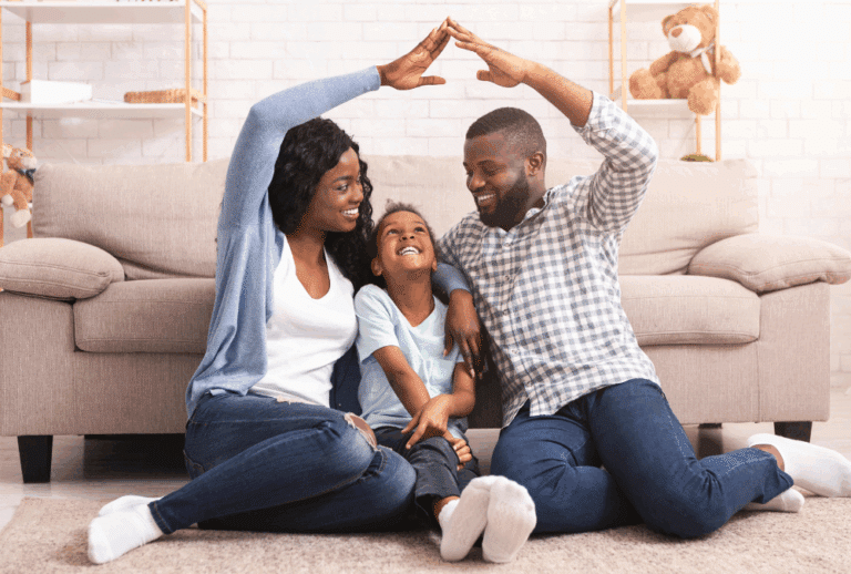 Image is of a set of African American parents making a house gesture over a young girl, concept of step-parent adoption in Franklin