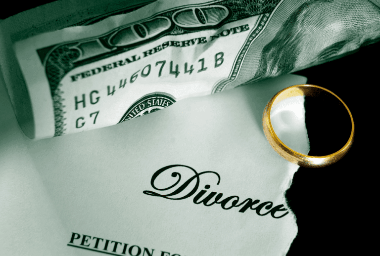 Image is of a divorce paper, wedding band, and crumpled American money, concept of finding hidden assets during a divorce in Franklin