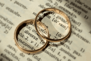 Image is of two gold wedding bands on a dictionary page for the word 'divorce', concept of religious vs. legal divorce in Franklin