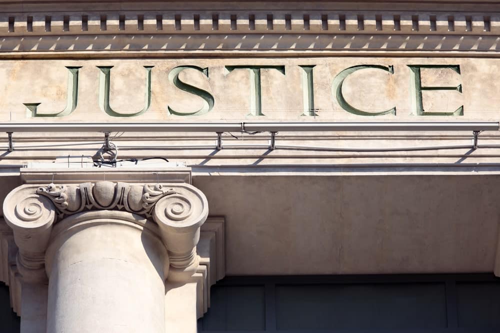 Image shows the word “Justice” carved on a courthouse building, representing Tennessee custody law and family court decisions.