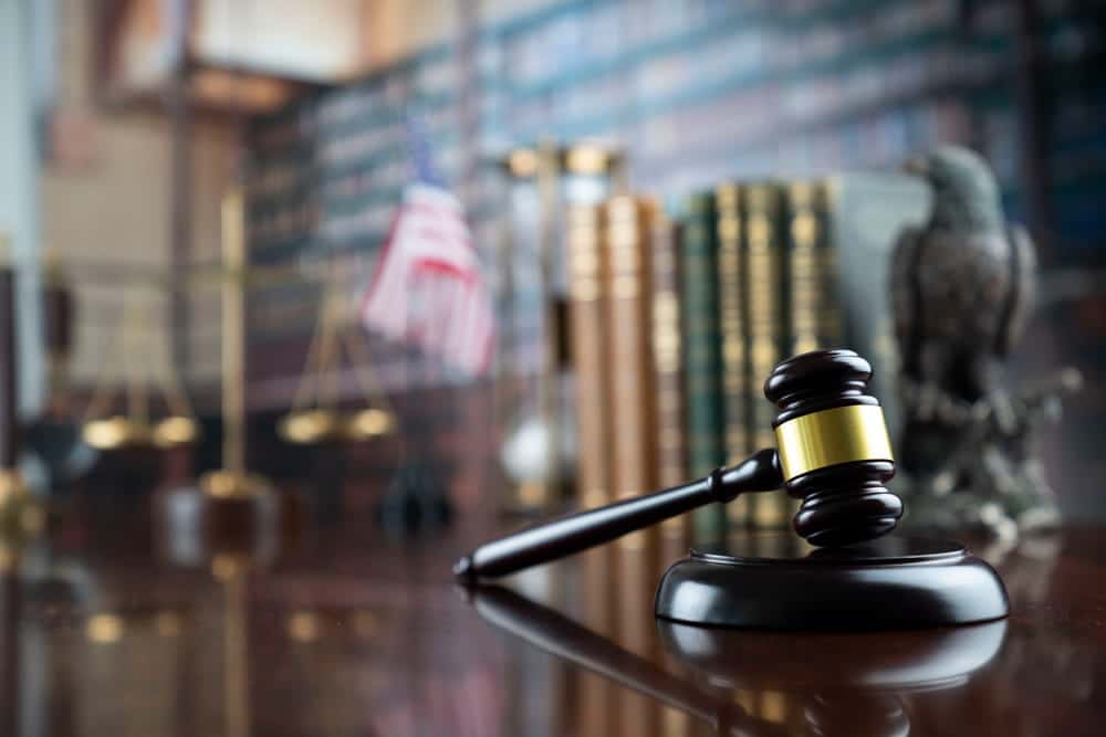 Image is of a judge’s gavel resting on a courtroom desk, representing legal decisions that affect child custody cases involving grandparents.