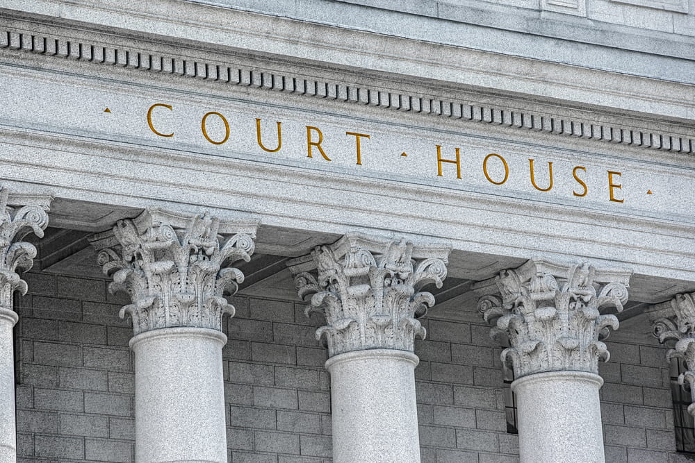 Image is of a courthouse building with tall columns, concept of custody disputes being resolved through family court during the holidays.