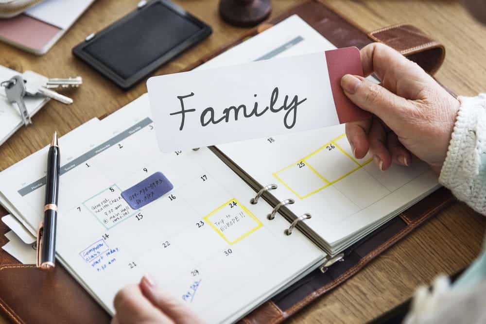 Image is of a parent reviewing a calendar labeled family, representing scheduling arrangements under custody orders in Tennessee.