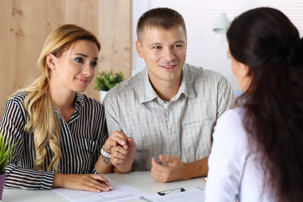 Image is of a couple meeting with a legal professional to discuss family adoption matters, concept of Franklin adoption lawyer.