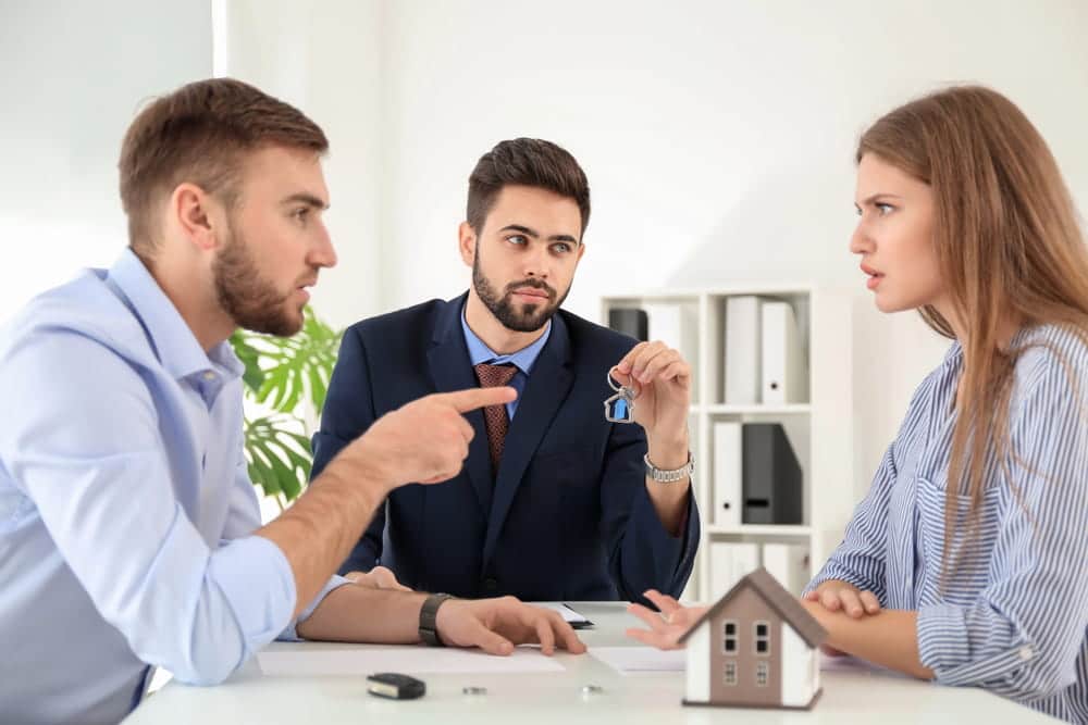Image is of a couple discussing property and assets with a lawyer, concept of Franklin divorce wealth protection and asset division