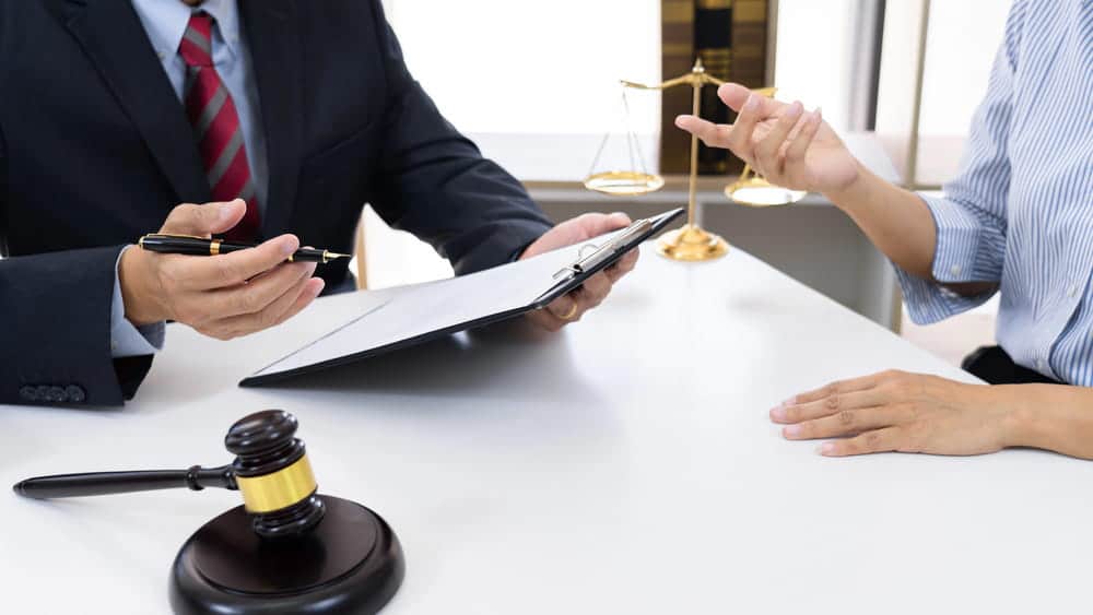Image is of an attorney meeting with a client, concept of legal separation attorney providing guidance before filing legal separation documents.