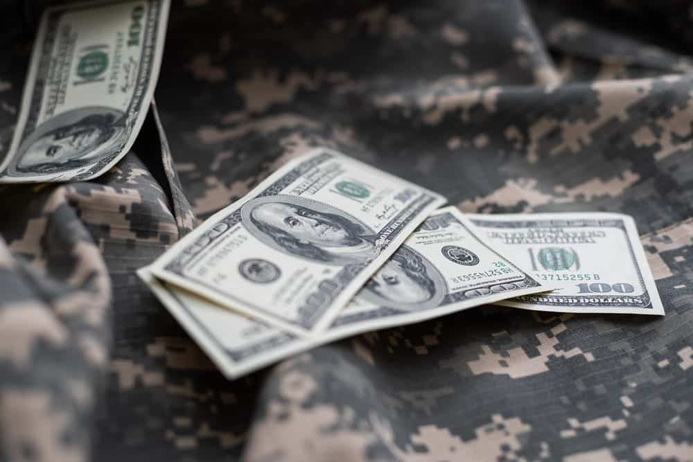 Image is of military uniform with cash, concept of military divorce lawyer addressing military pay and financial issues during divorce.