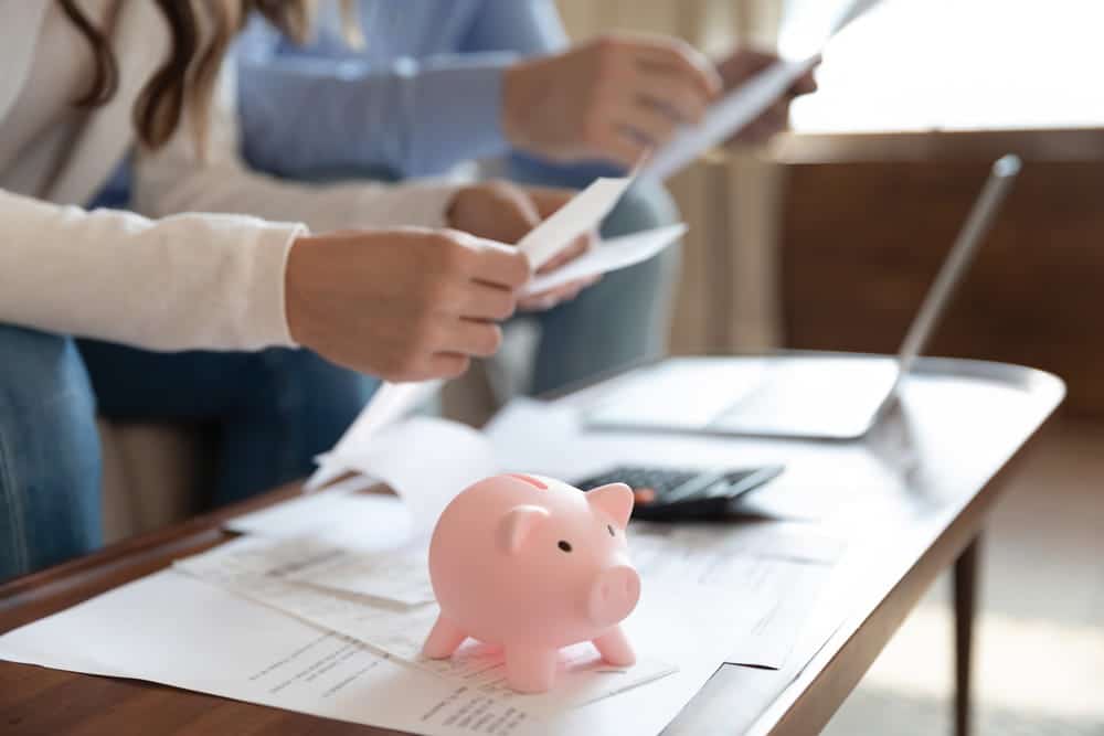 Image is of two people reviewing finances, concept of handling a join bank account during divorce