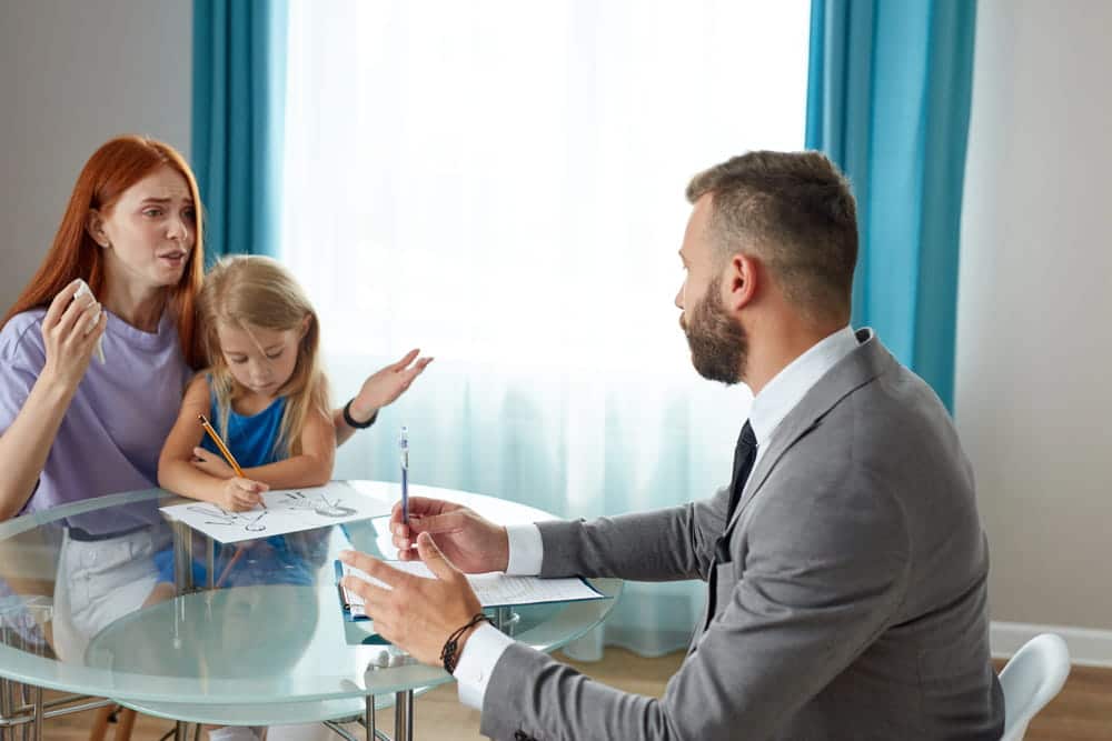Image is of a parent meeting with an attorney to discuss child custody, concept of sole custody in Tennessee.