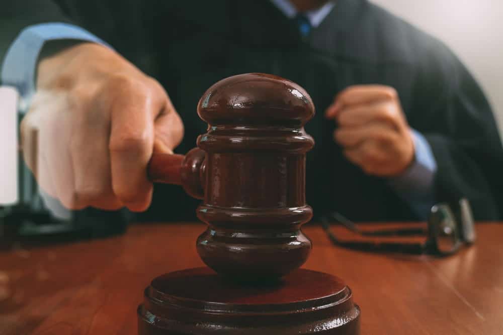Image is of a judge using a gavel during court proceedings, concept of sole custody in Tennessee.