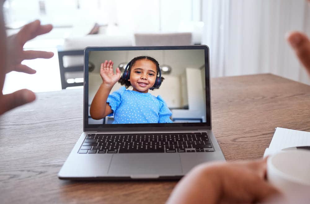 Image is of a child talking with a parent by video call, representing long distance communication considered by a Tennessee court.